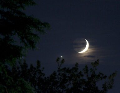 Bright Venus shining beside a thin crescent Moon in the evening sky.