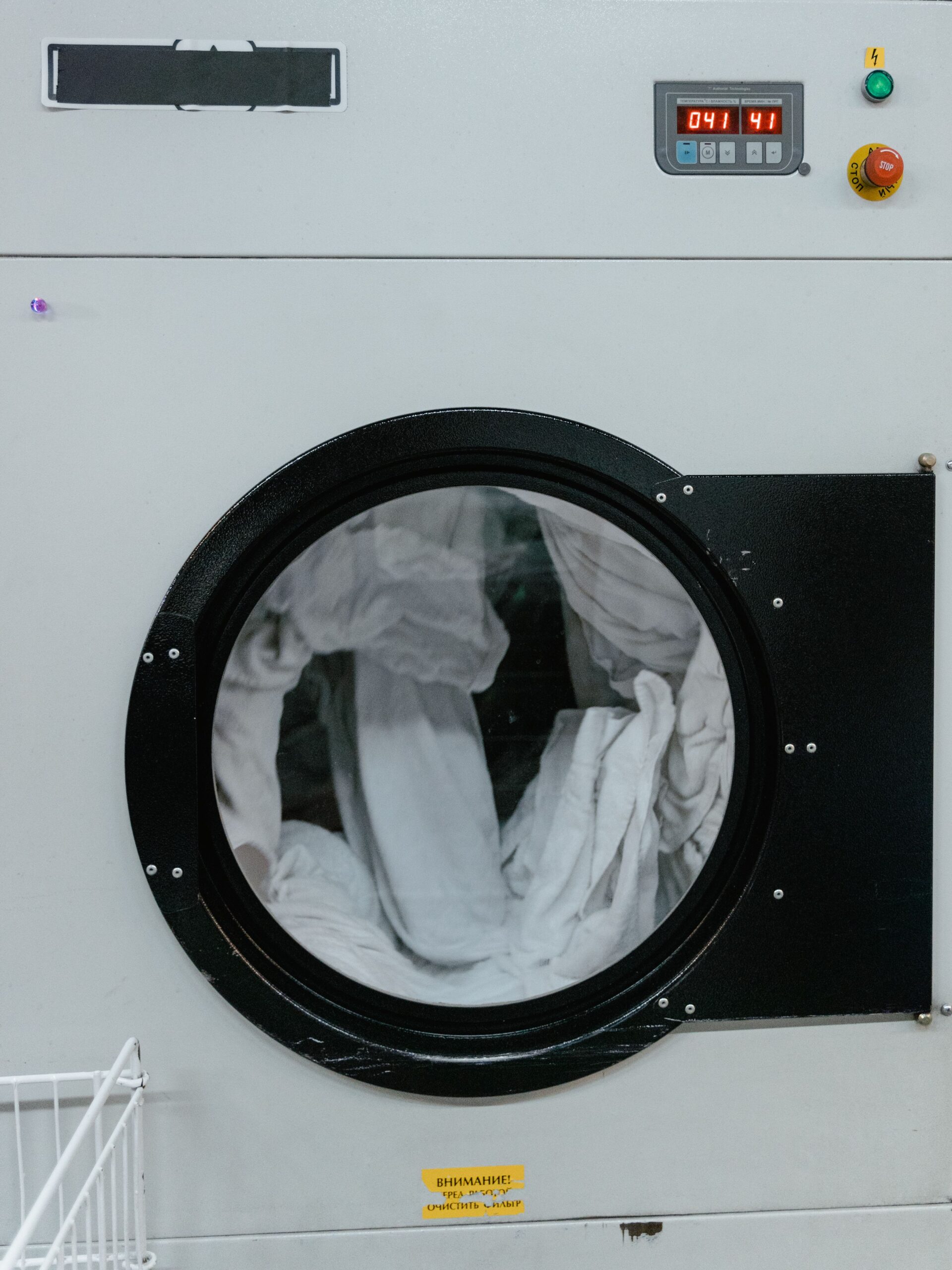 Fabric tumbling inside a washing machine during a wash cycle.