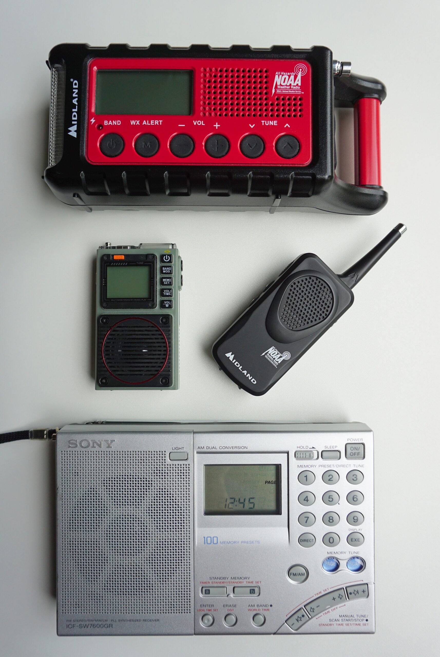 Portable radios and weather alert receivers arranged together