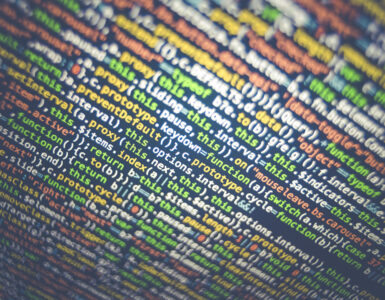 Close-up of colorful computer code on a dark screen, suggesting software values and limits.
