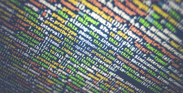 Close-up of colorful computer code on a dark screen, suggesting software values and limits.
