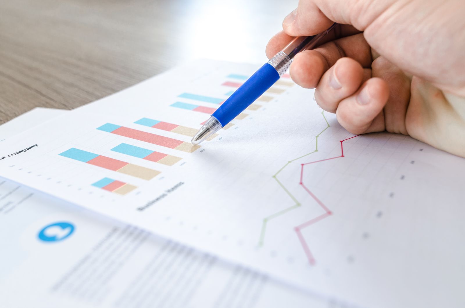 Printed data charts representing how z-scores describe distance from the center of a distribution.