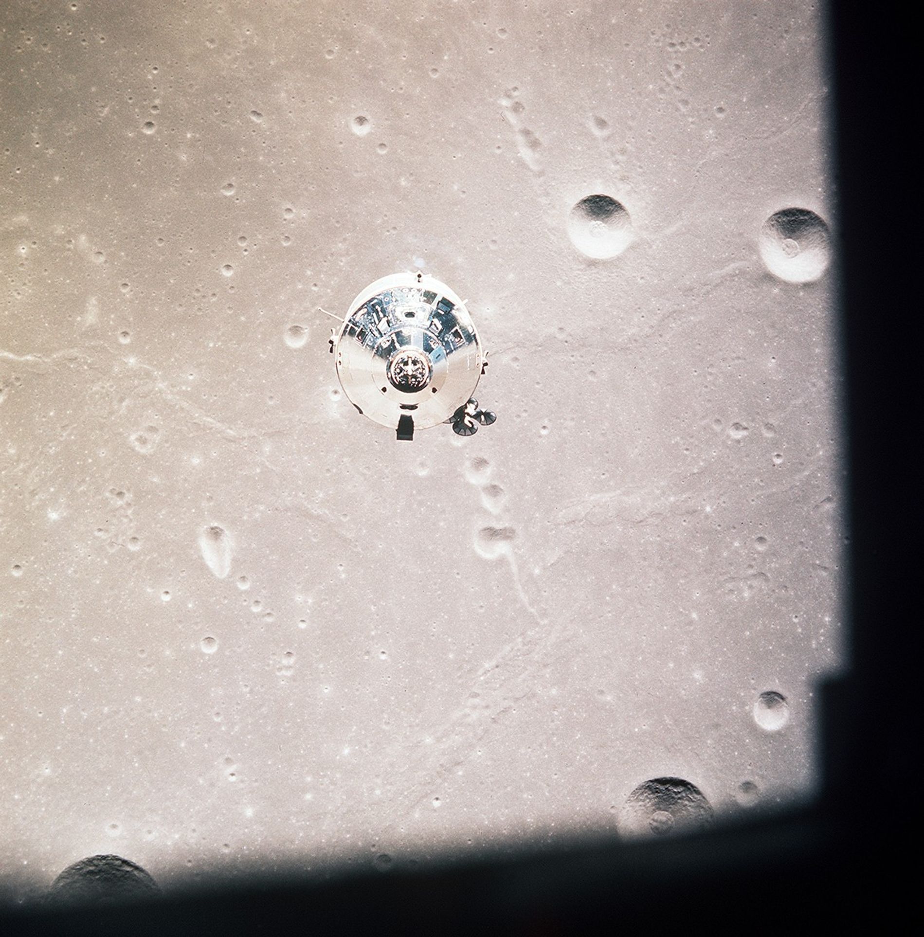 Apollo 11 command and service modules orbiting above the Moon