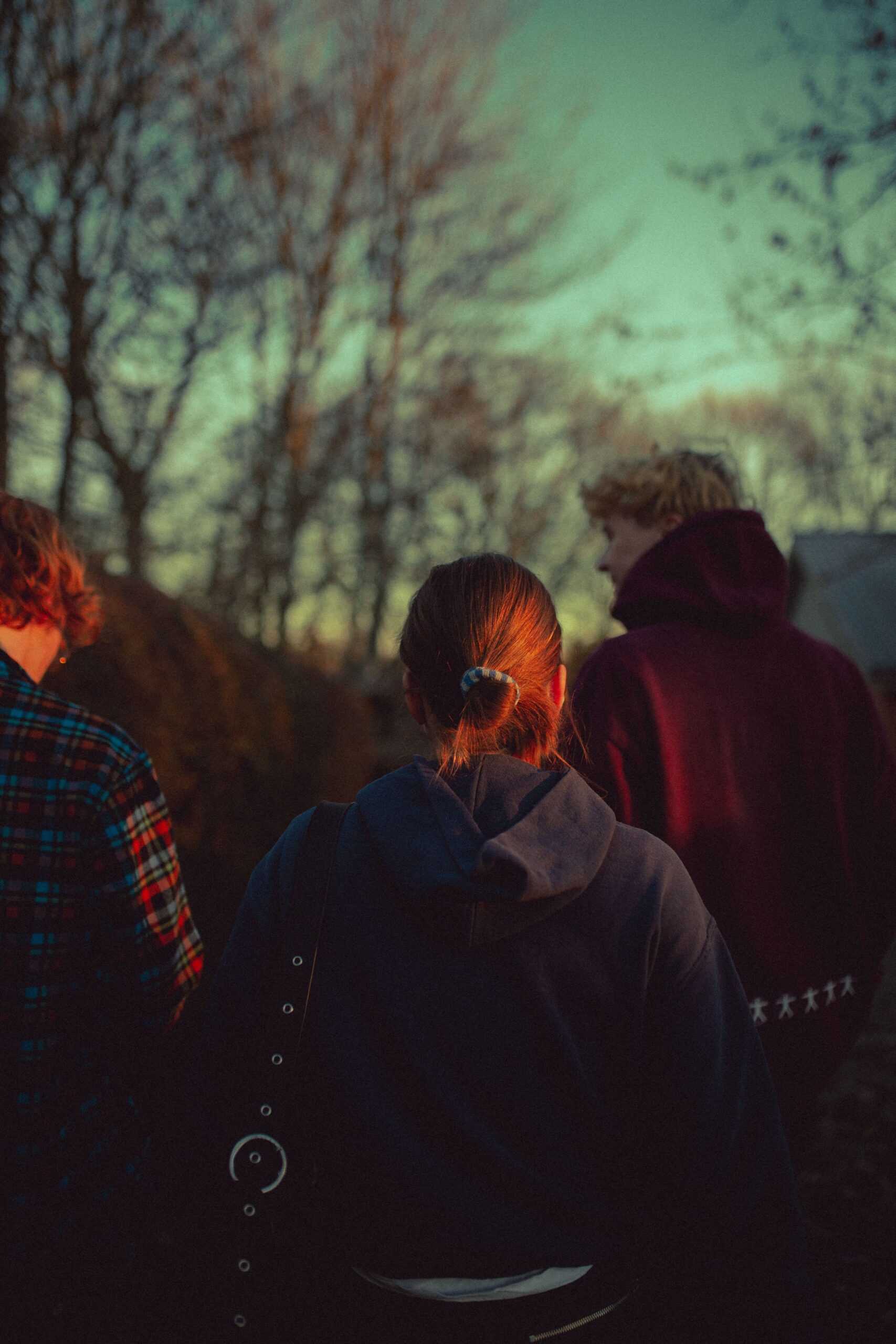 Young people walking outdoors in soft autumn morning sunlight