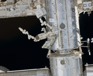 The International Space Station orbiting above Earth, where researchers study brain organoids in microgravity