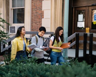 Three college students walking together on a university campus