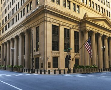 Federal Reserve Bank building with columns and an American flag