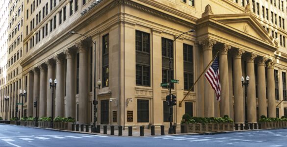 Federal Reserve Bank building with columns and an American flag