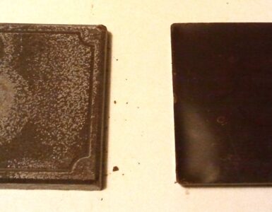 Two chocolate squares, one with a pale coating caused by fat bloom