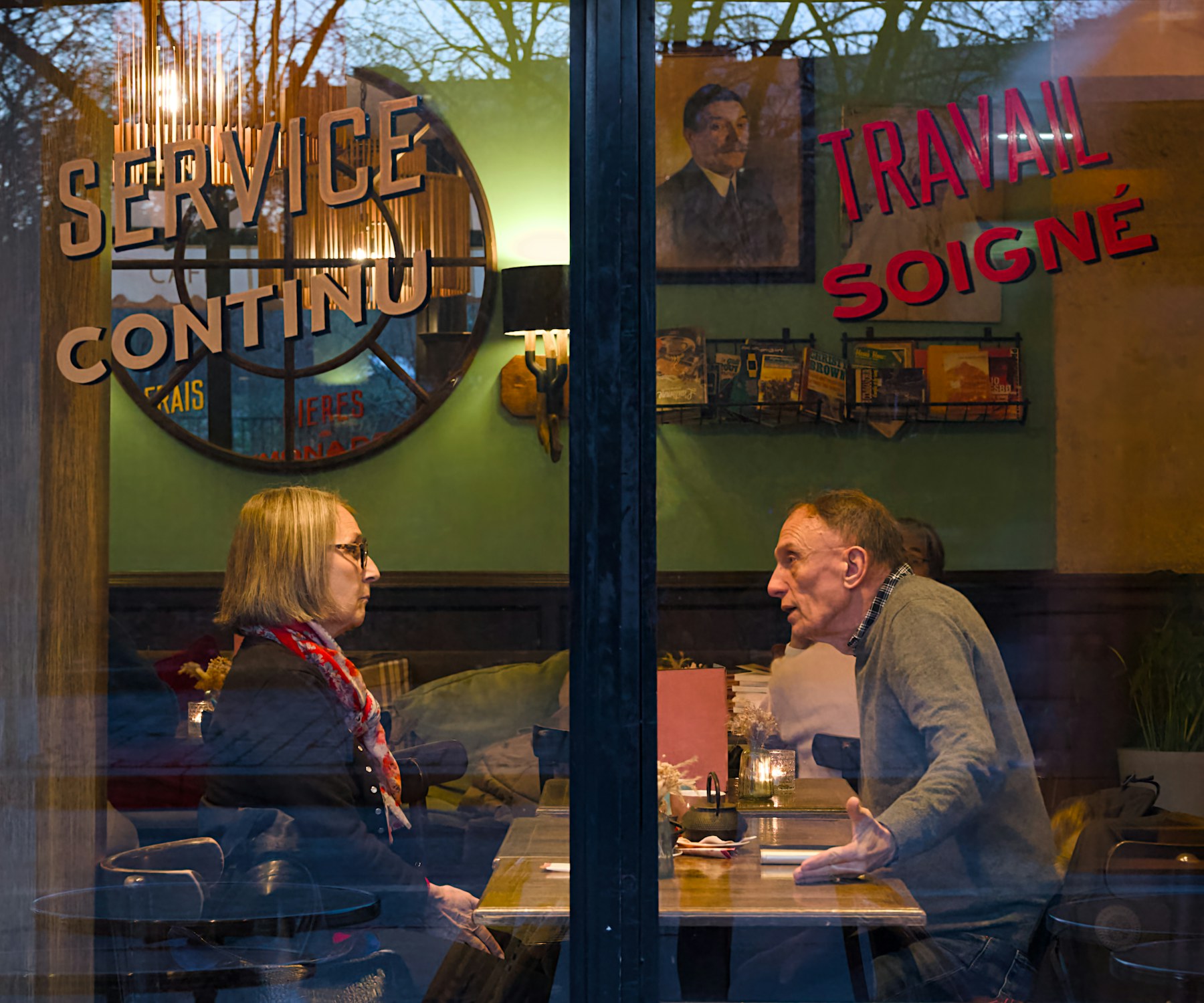 Two people talking together at a cafe table
