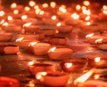 Rows of clay diya lamps glowing during a Diwali celebration