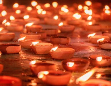 Rows of clay diya lamps glowing during a Diwali celebration