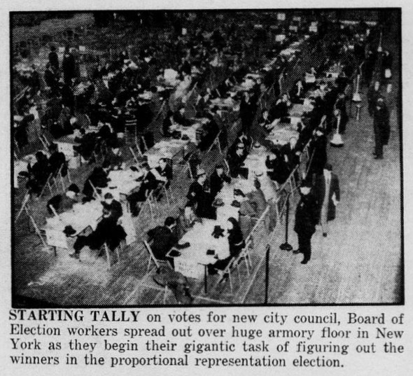 Election workers sort and count paper ballots at long tables