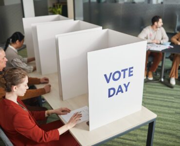 Voters and election workers inside a busy polling place