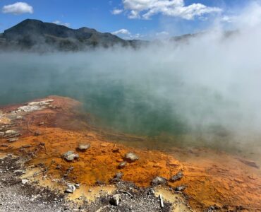 Steam rising from a mineral-rich geothermal pool