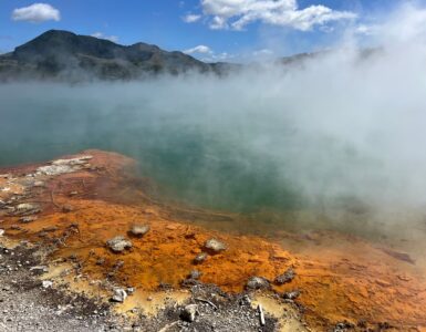 Steam rising from a mineral-rich geothermal pool