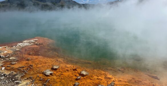 Steam rising from a mineral-rich geothermal pool