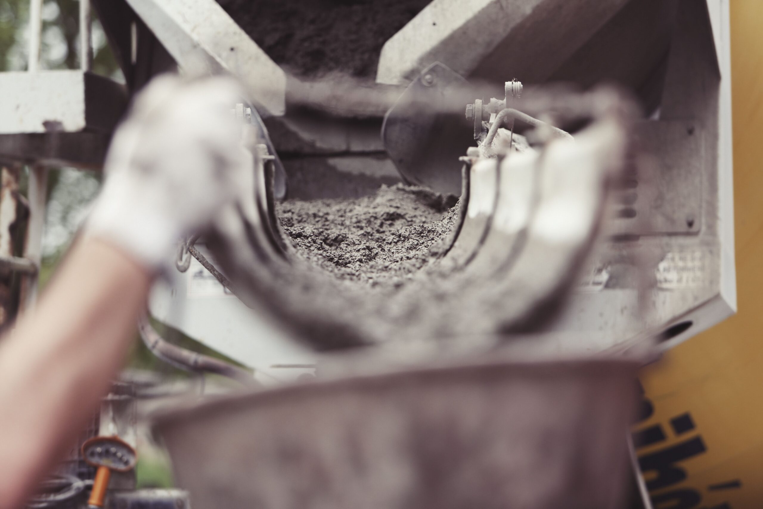Close view of fresh concrete flowing from a mixer truck chute