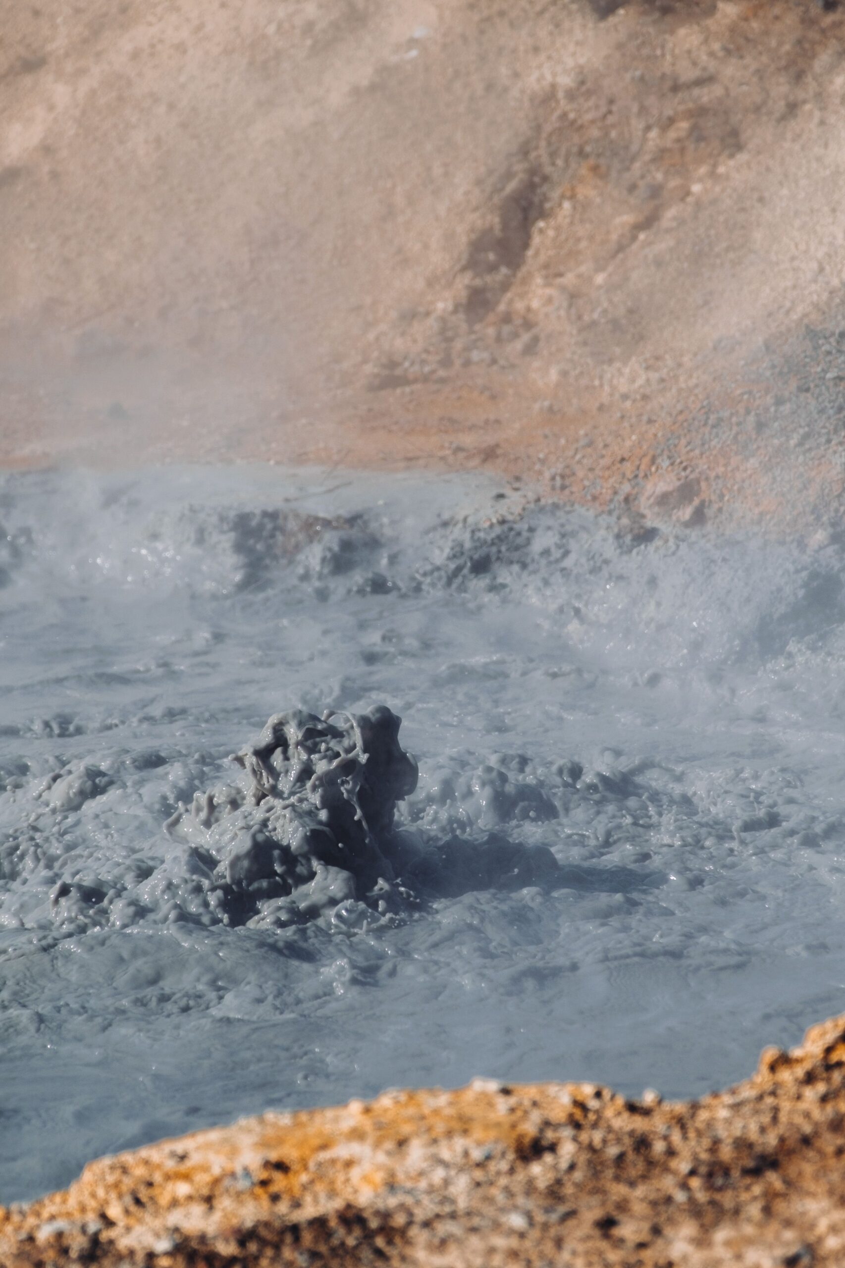 Close view of a bubbling geothermal mud pool