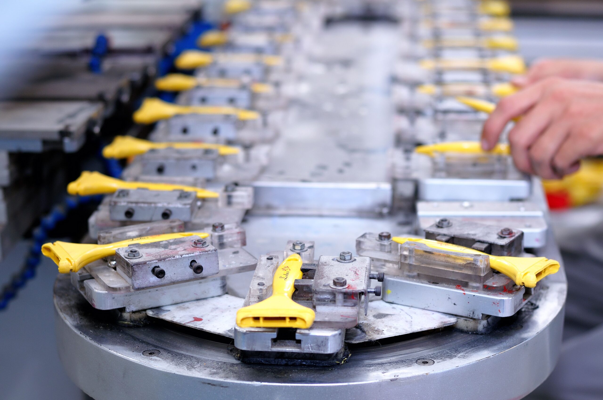 Yellow components moving through a factory production line