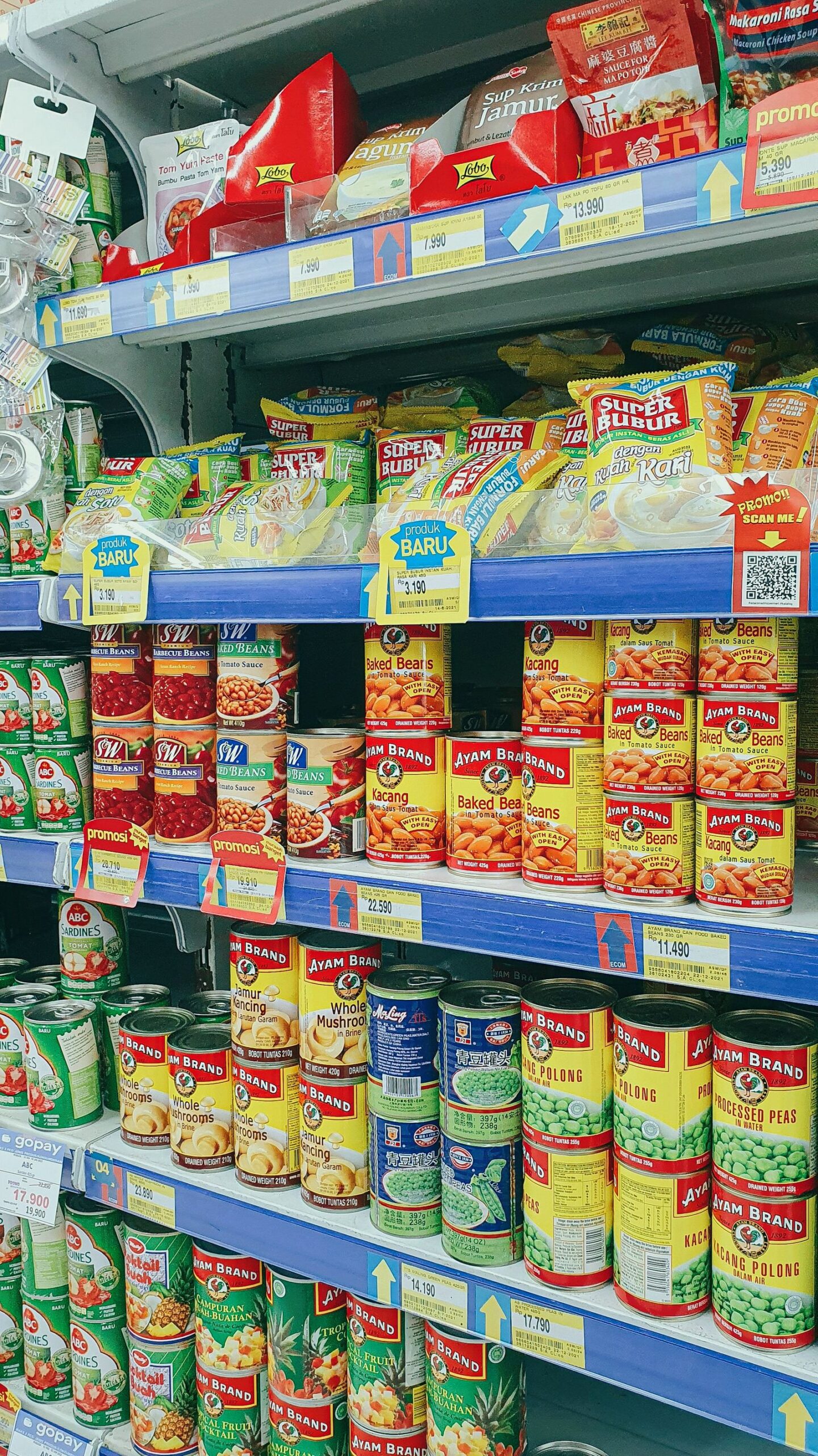Canned and packaged foods arranged on grocery store shelves