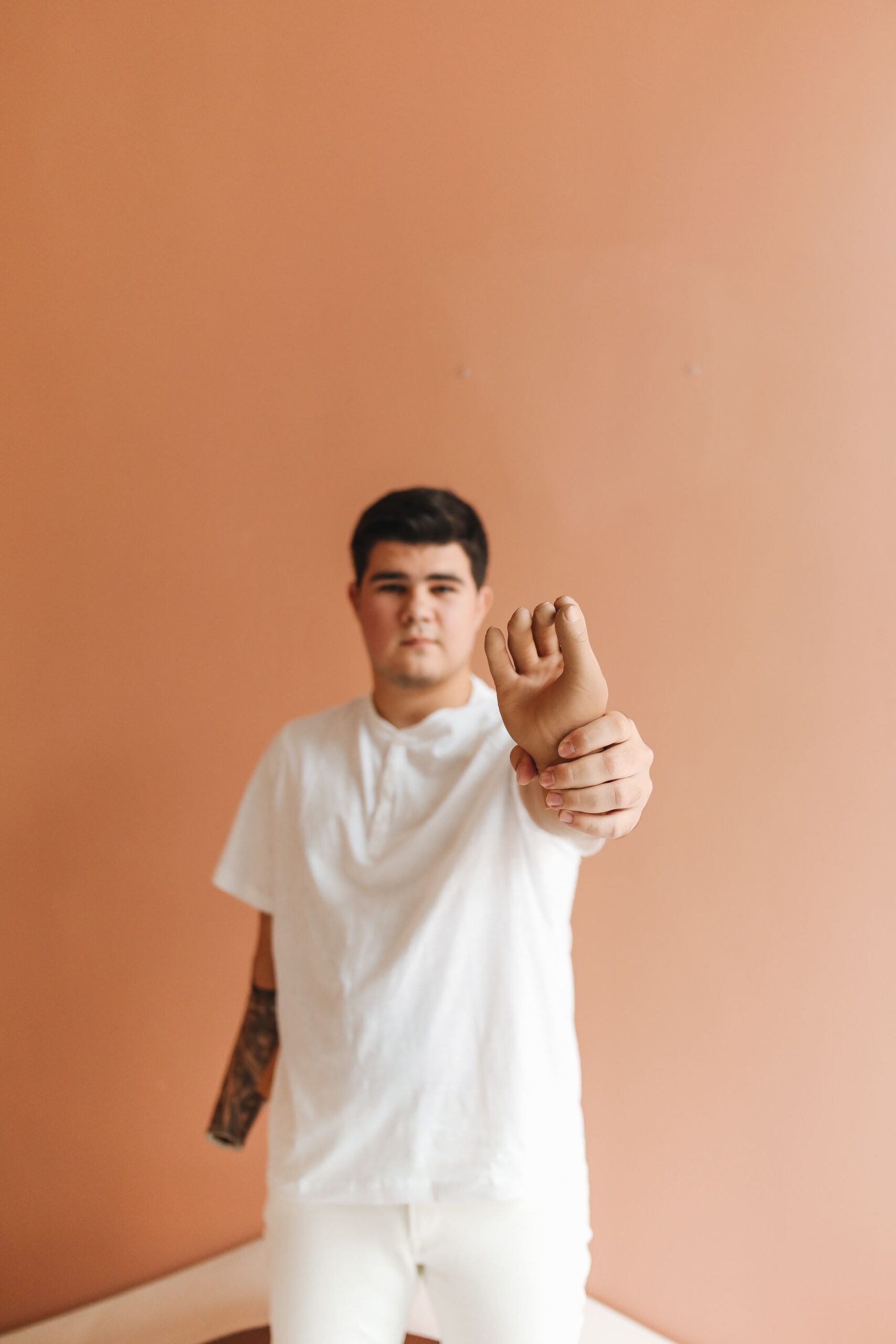 A person holding and examining a prosthetic hand