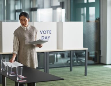 Poll worker organizing voting materials before voters arrive
