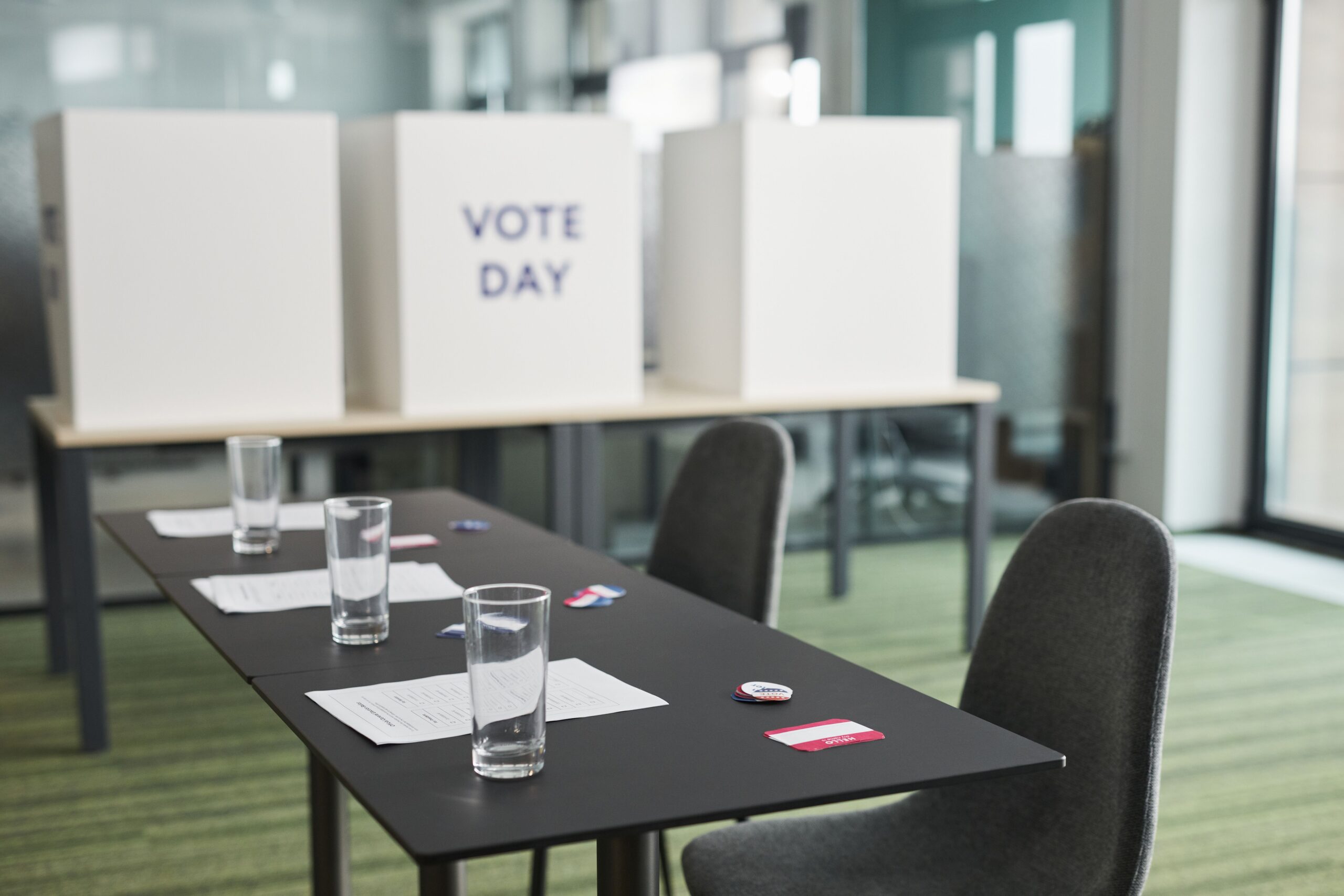 Prepared polling place with privacy booths, tables, and chairs before opening