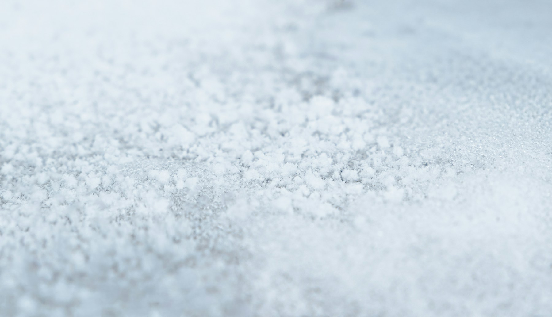 Close-up view of coarse white salt crystals like those used to make deicing brine