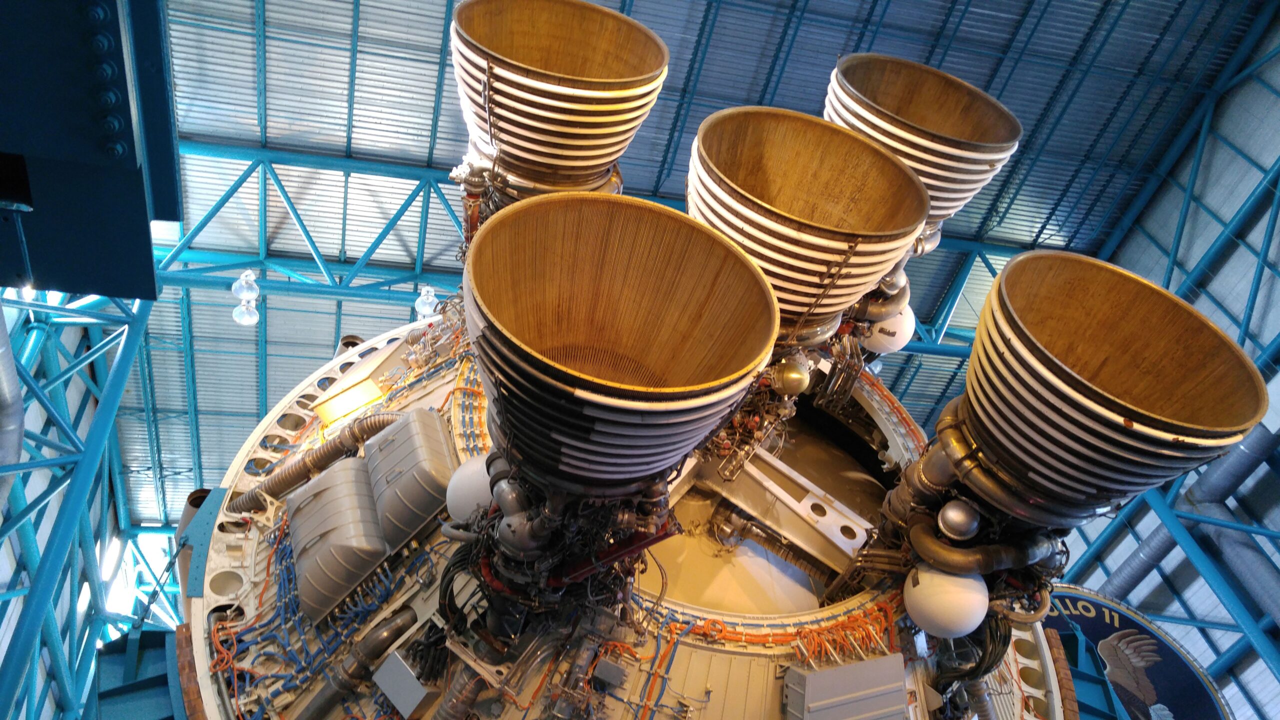 Large rocket engines beneath a Saturn V stage in a museum
