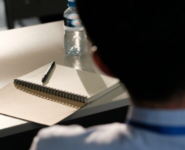 Student preparing a notebook during a language class