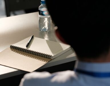 Student preparing a notebook during a language class
