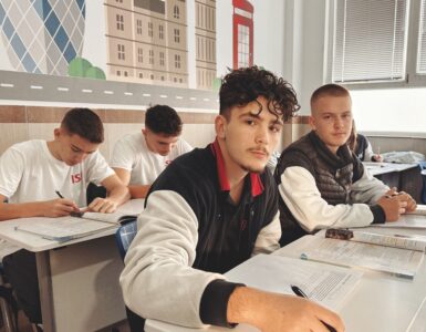 Teenage students studying together in a classroom