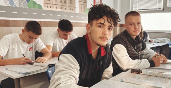 Teenage students studying together in a classroom