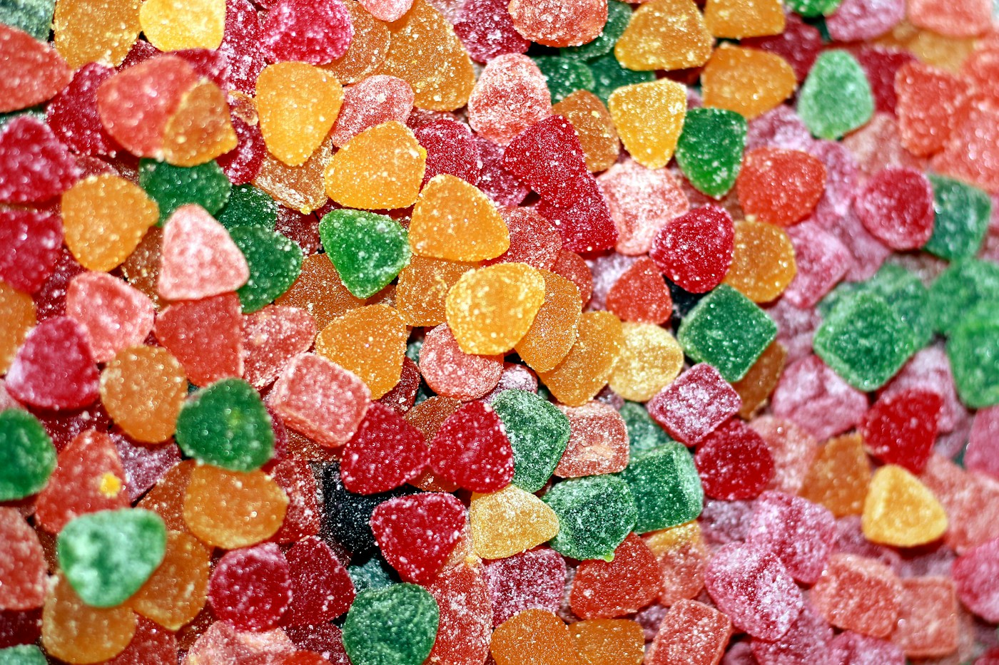 Heart-shaped gummy candies coated with visible sugar crystals