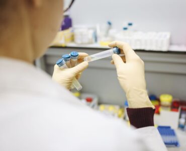 Scientist examining test tubes in a laboratory
