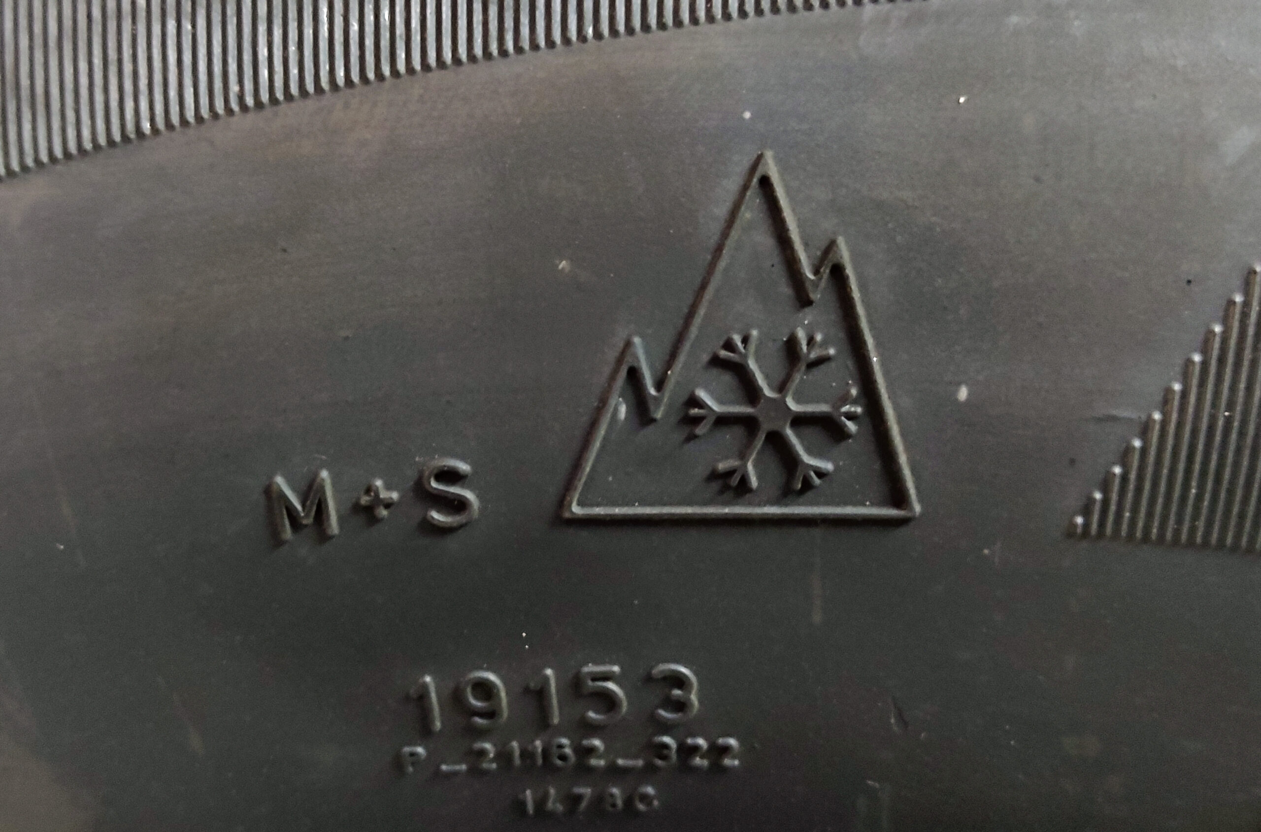 Three-Peak Mountain Snowflake symbol molded into a winter tire sidewall