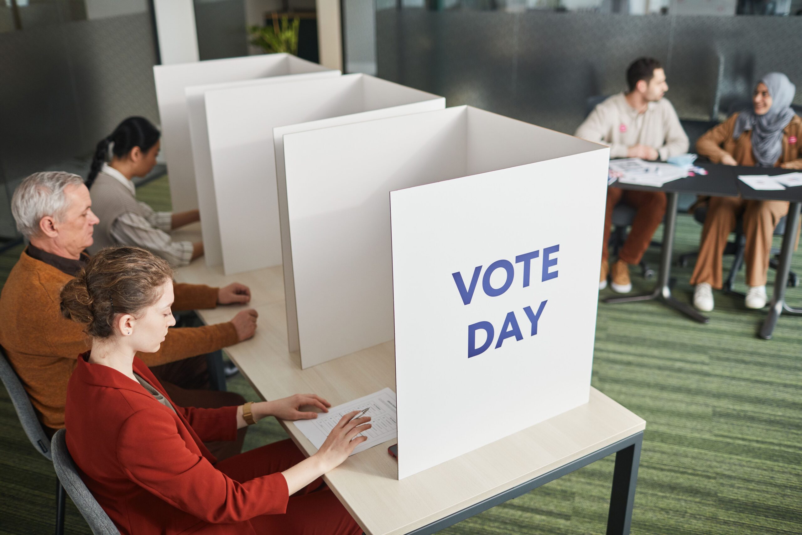 Voters and poll workers inside an indoor polling place
